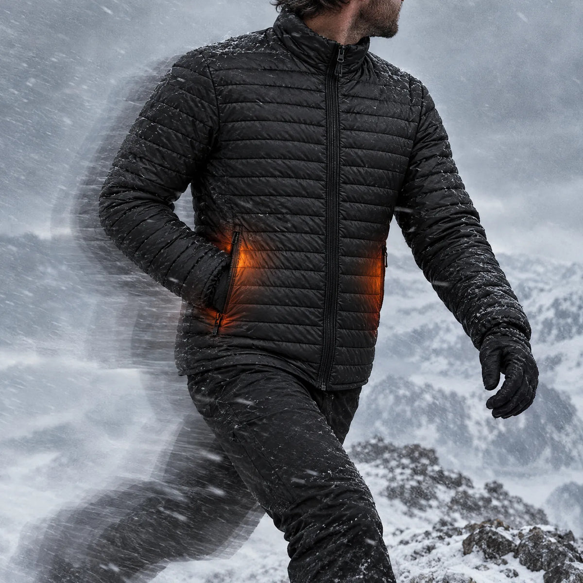 Man striding into the wind on a snowy ridge in the Basecamp men's heated jacket, pocket heat glowing