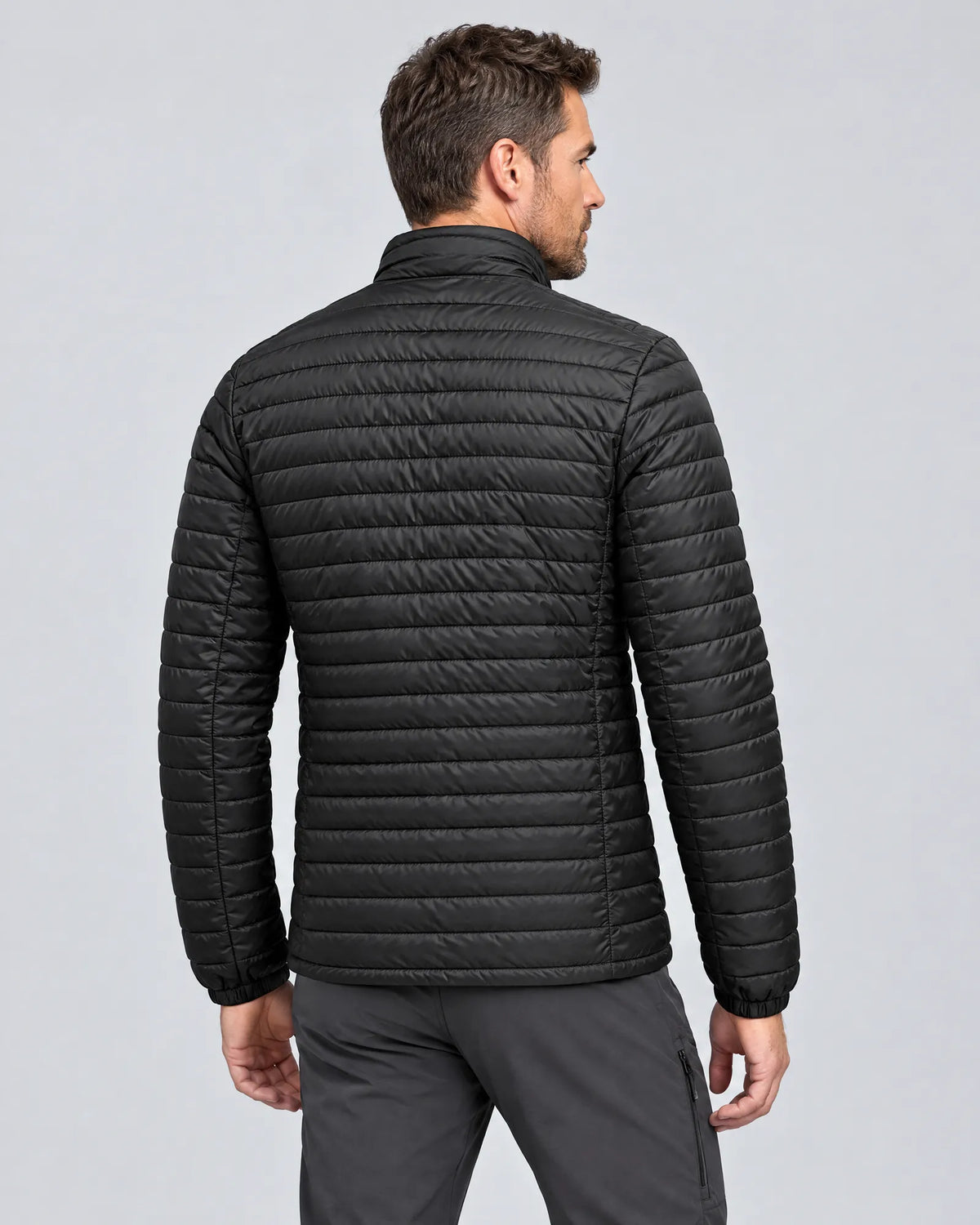 Model wearing the Basecamp men's heated jacket, three-quarter back view