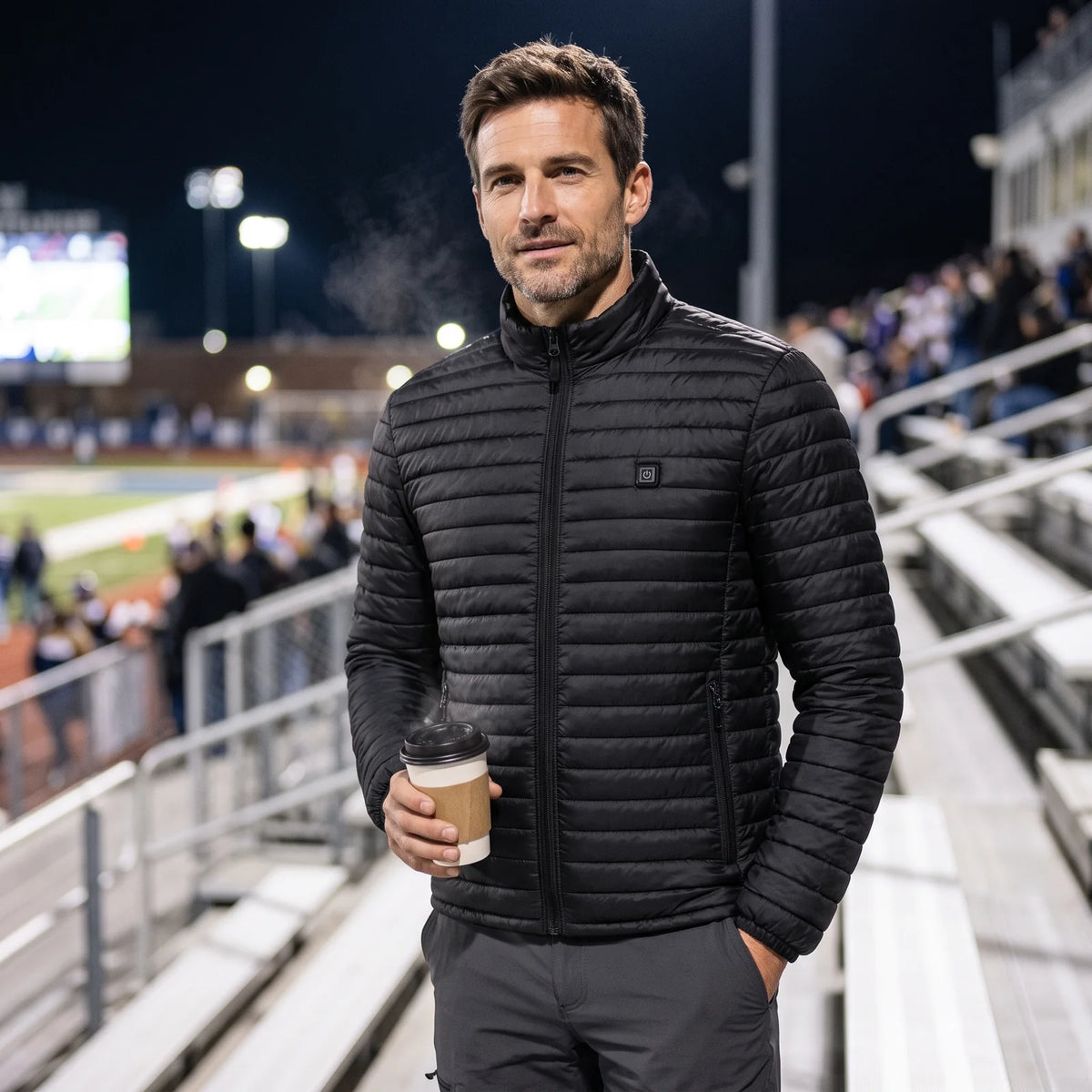 Fan at a cold night game in the Basecamp men's heated jacket