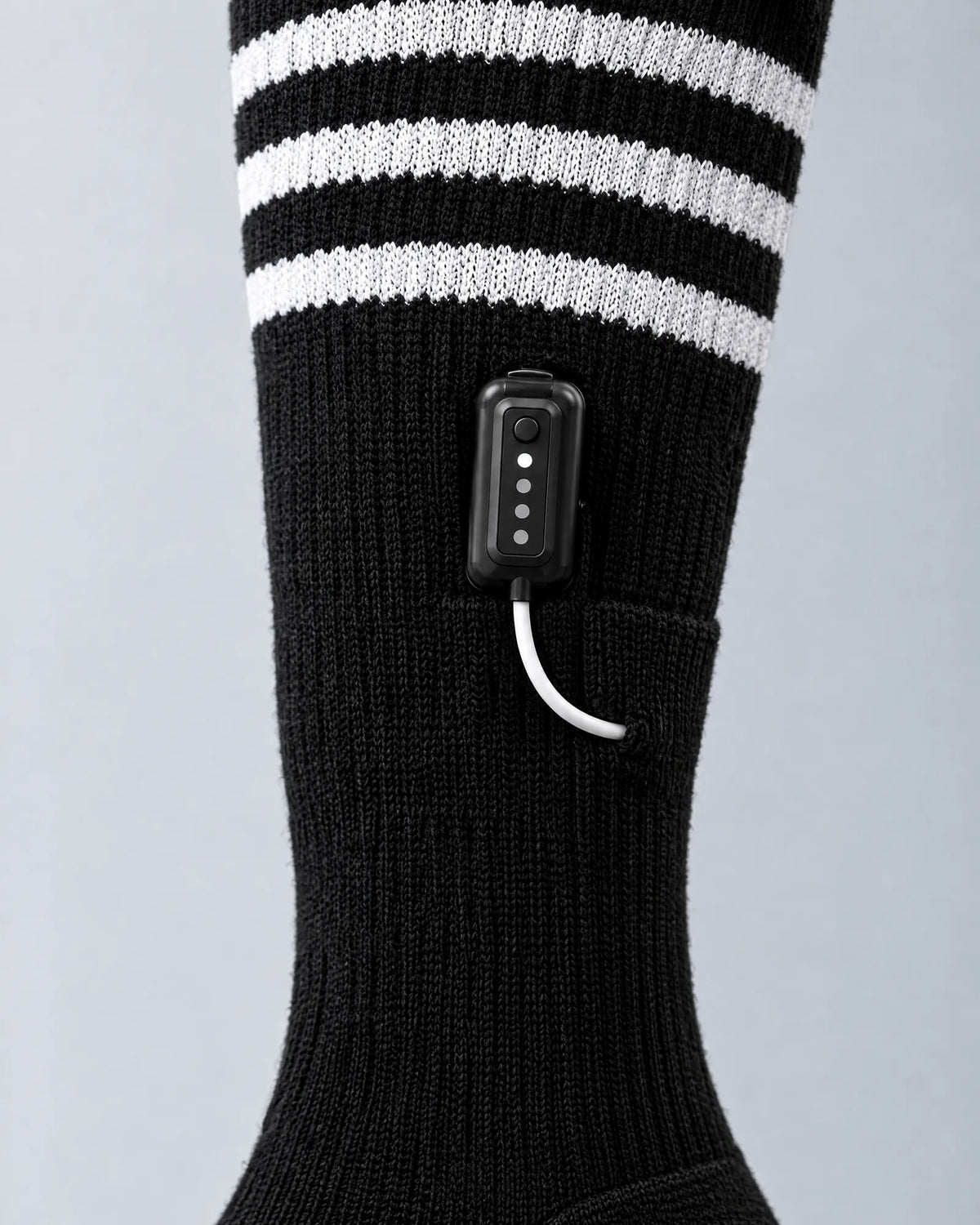 Close-up of the Switchback sock battery clipped on the outer calf