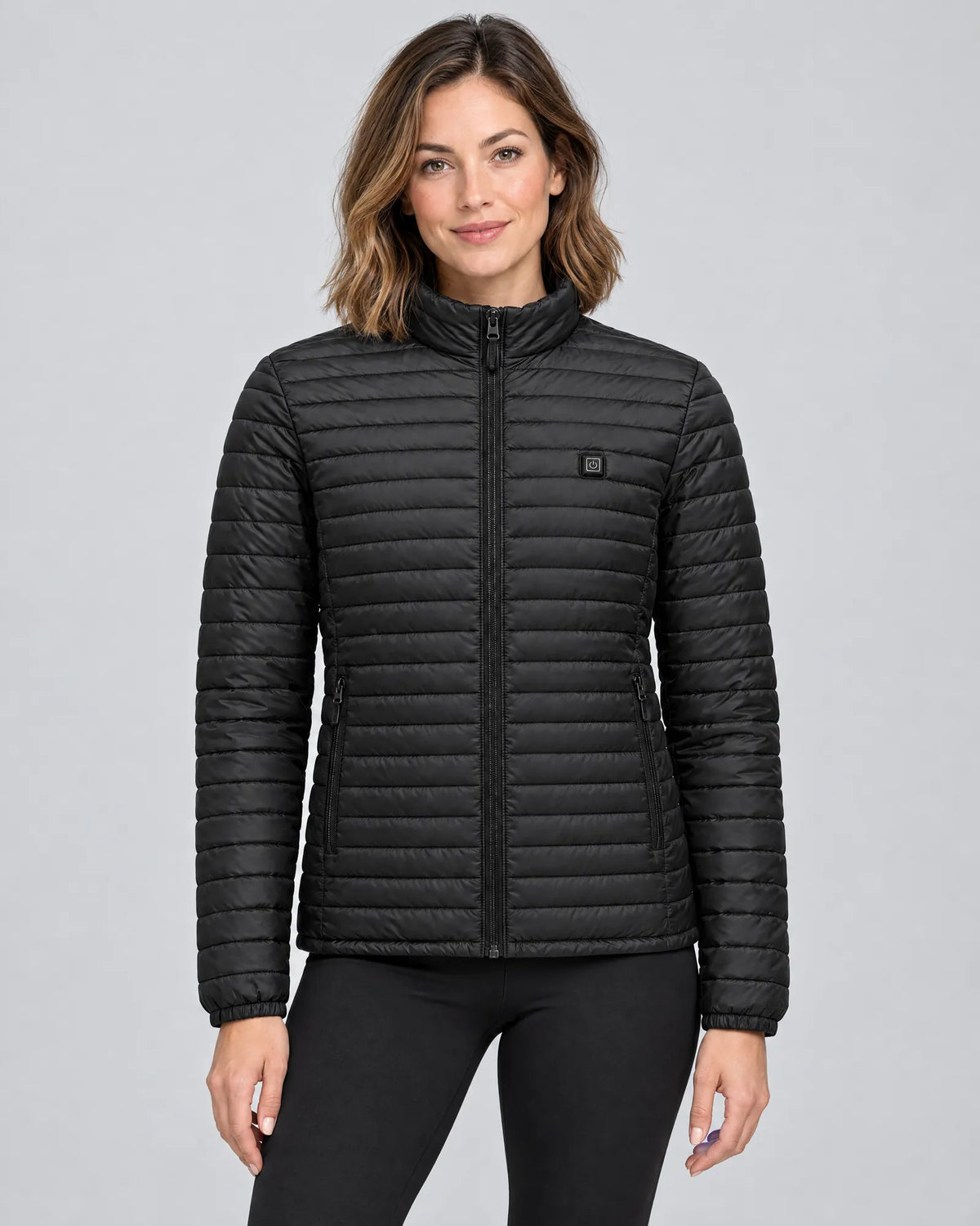 Model wearing the Basecamp women's heated jacket, front view