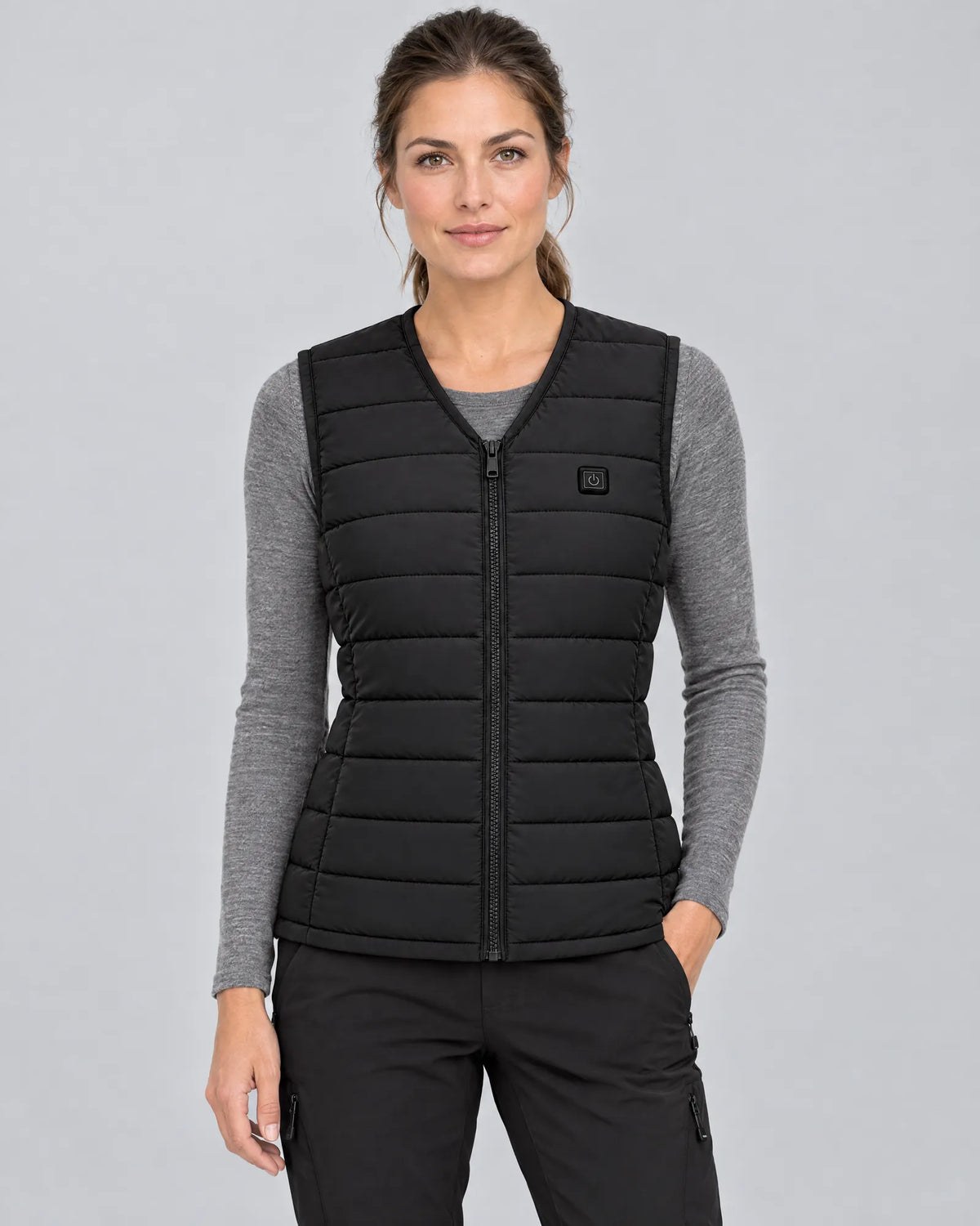 Model wearing the Ridgeline women's heated vest over a grey base layer, front view