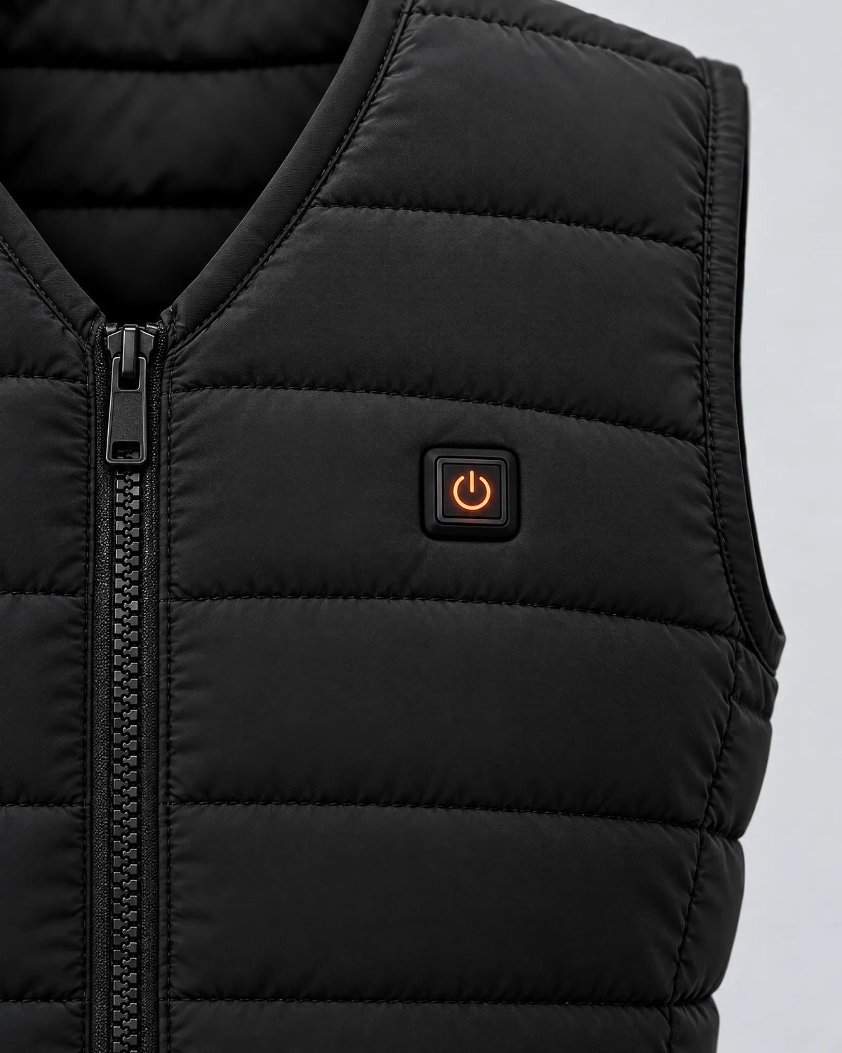 Close-up of the Ridgeline vest power button glowing orange